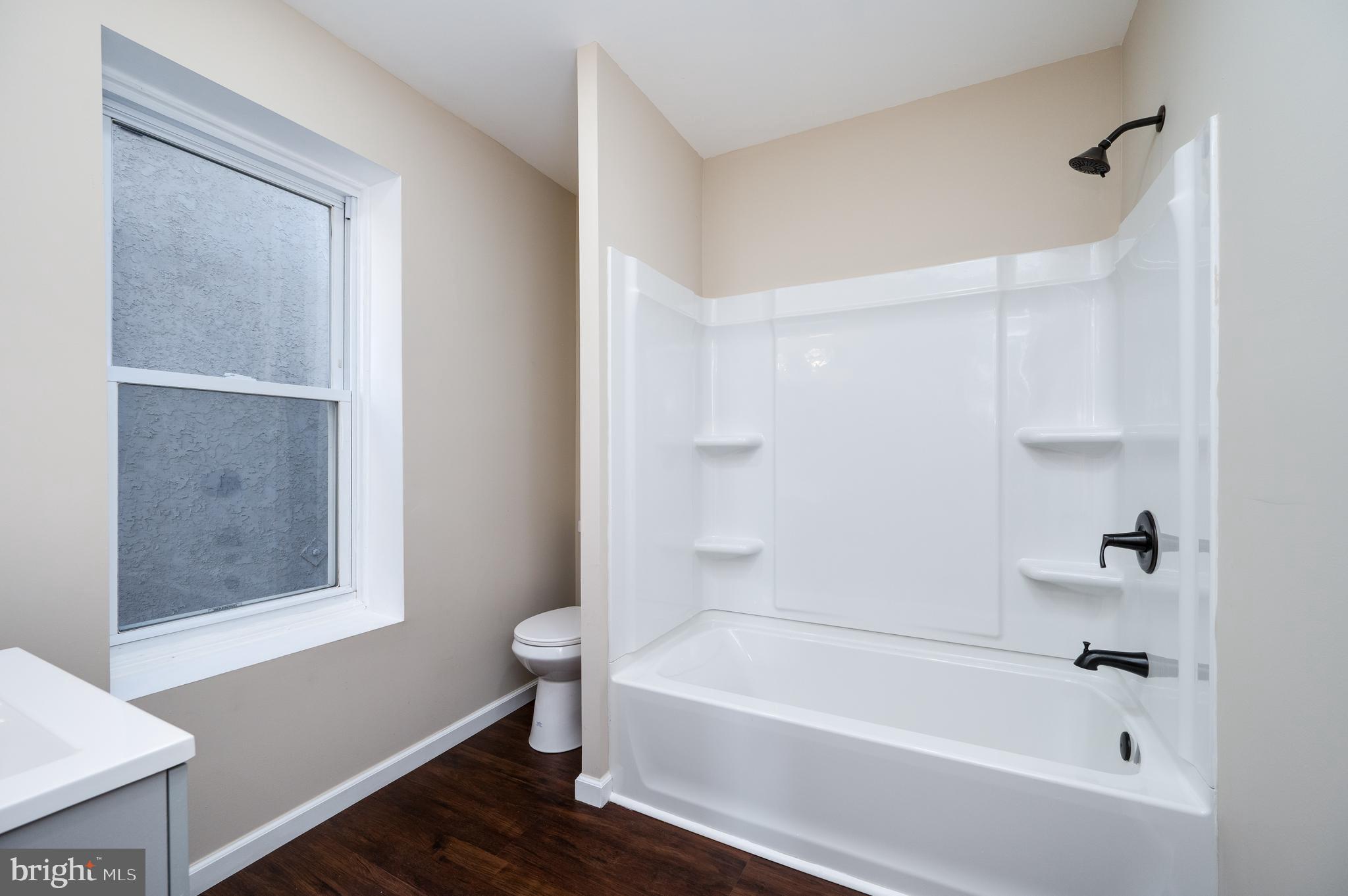 137 Elm Street Reading, PA 19601 - Photo 29 of 49 a white bath tub sitting next to a white sink and vanity