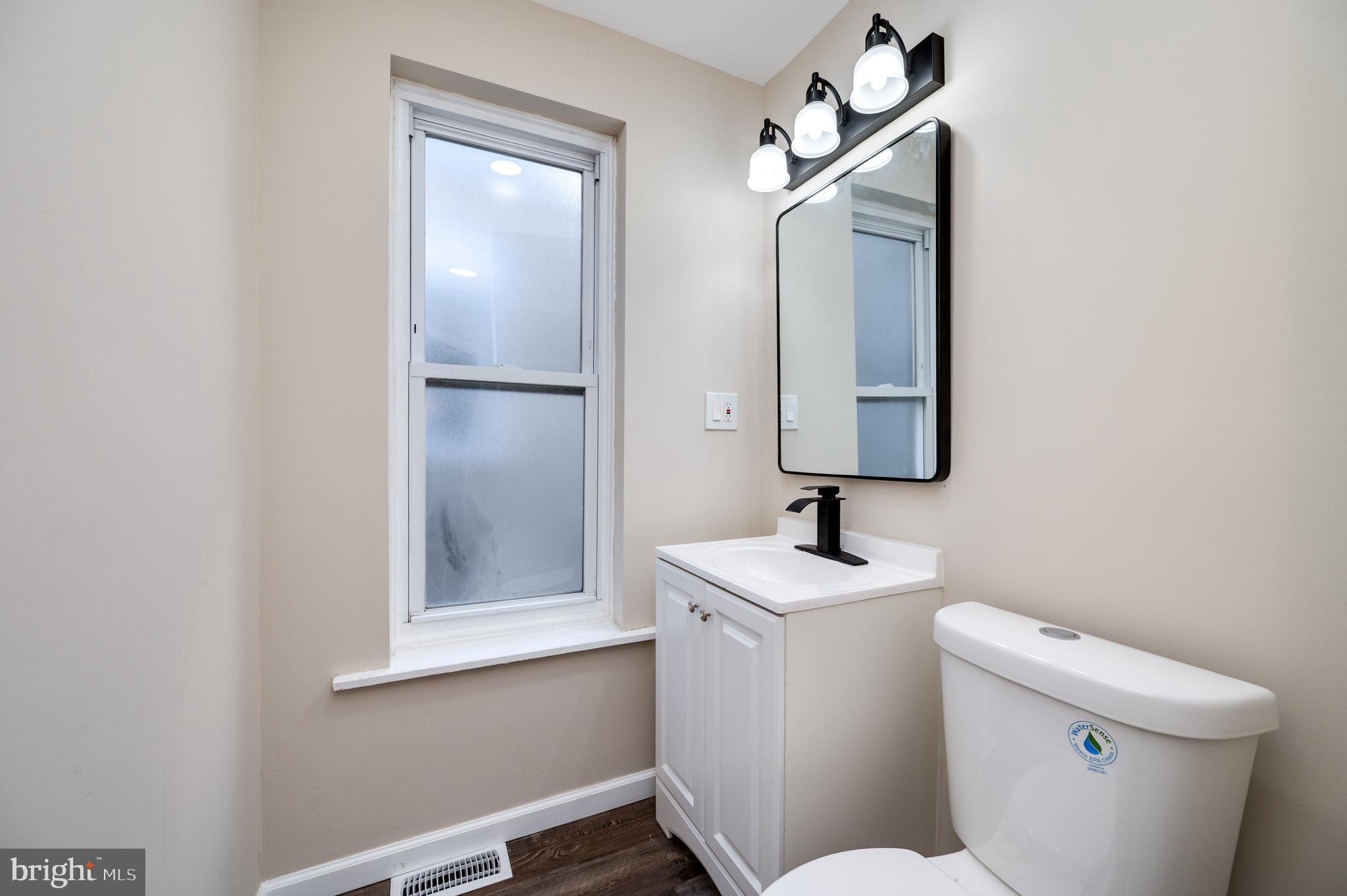 137 Elm Street Reading, PA 19601 - Photo 32 of 49 a bathroom with a toilet sink and mirror