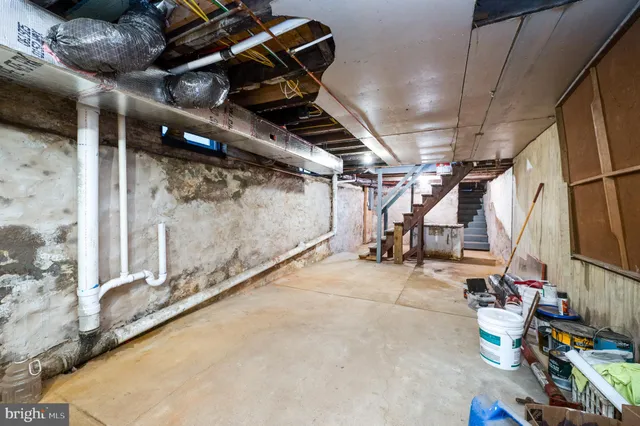 a white house that has tree in front of it