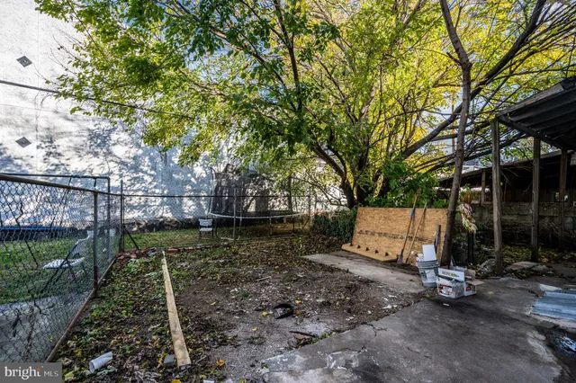 a backyard of a house with large trees