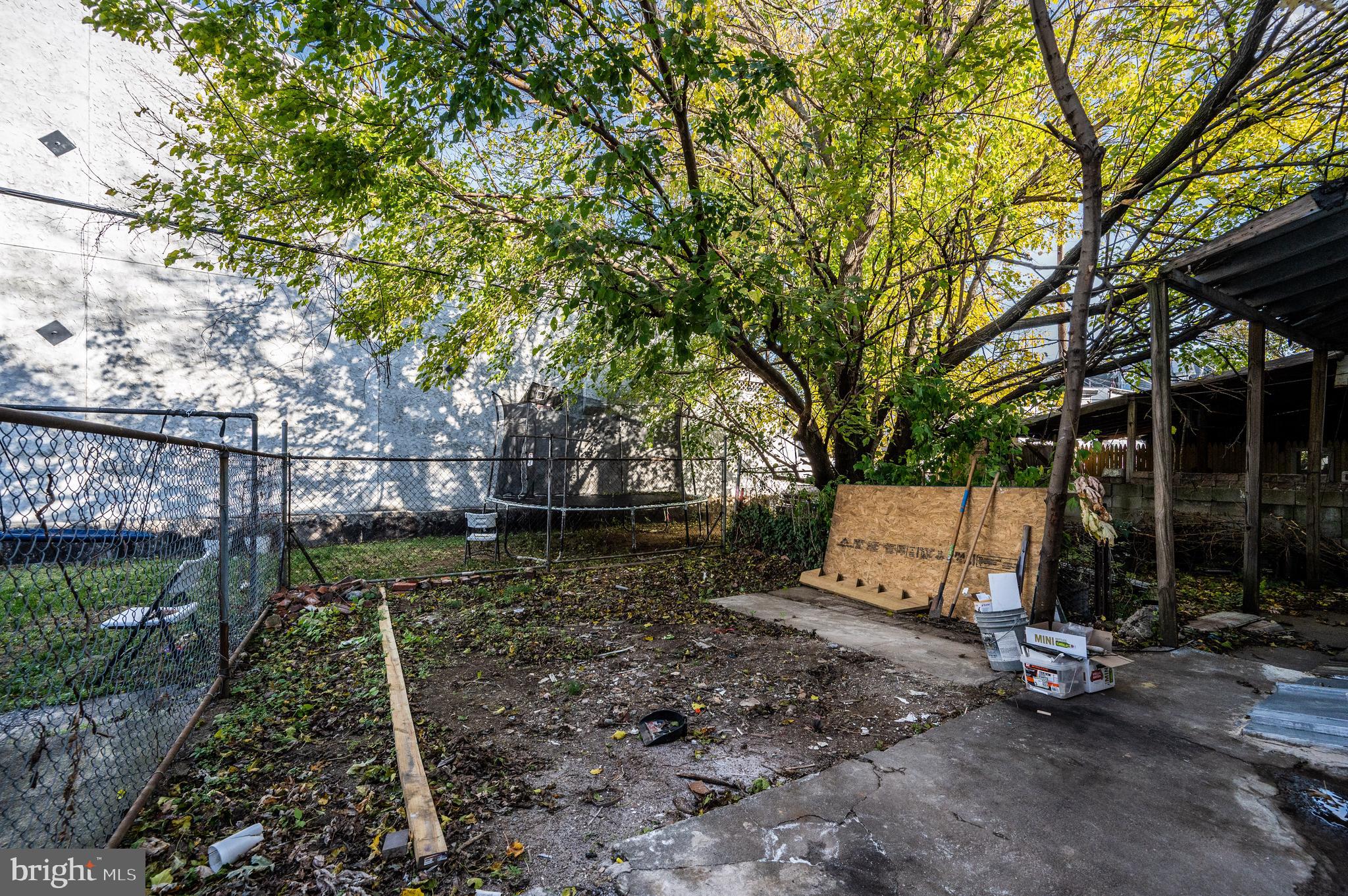 137 Elm Street Reading, PA 19601 - Photo 48 of 49 a view of a backyard with large trees and a barn