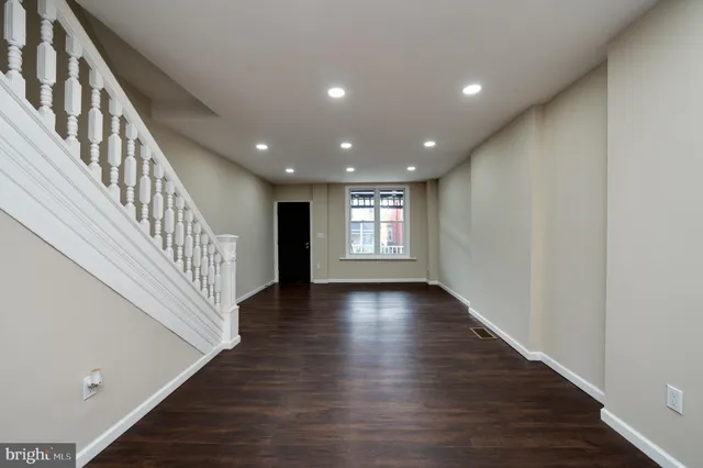 a view of an entryway with wooden floor