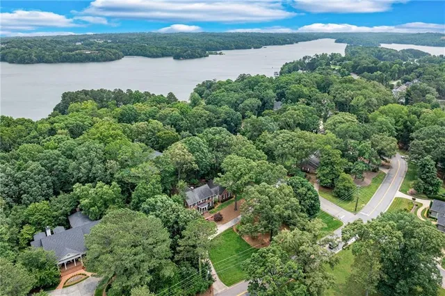 an aerial view of a house with outdoor space and lake view