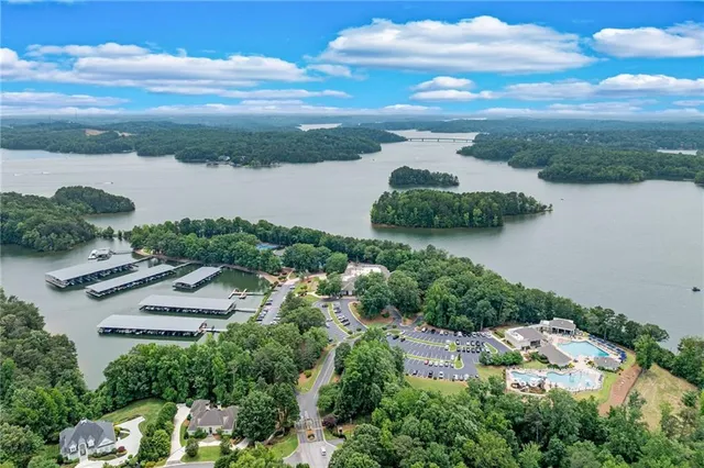 a front view of a house with a yard and potted plants