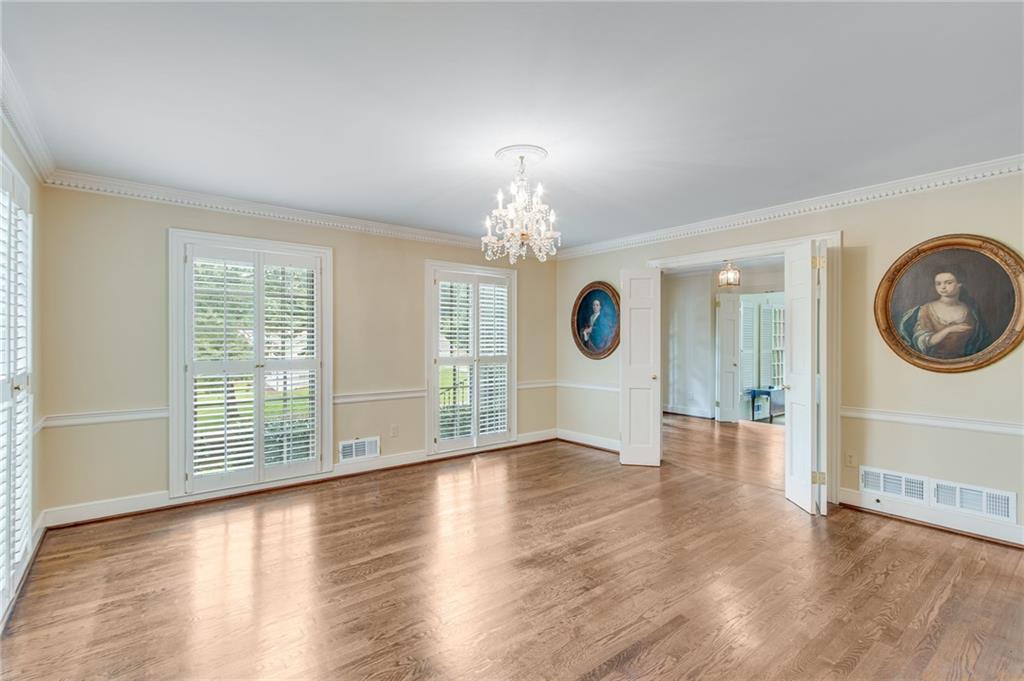 2626 Club Drive Gainesville, GA 30506 - Photo 40 of 71 an empty room with wooden floor chandelier and windows