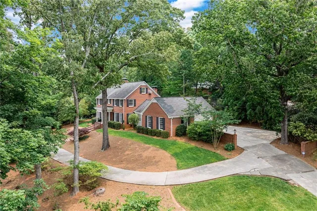 a view of a park with large trees