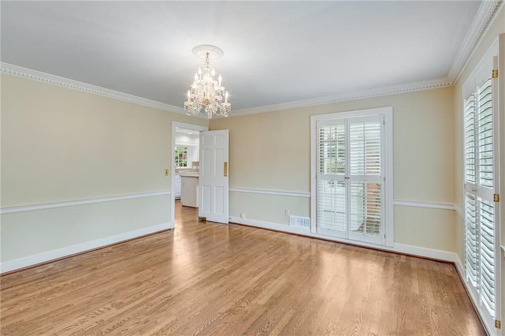 2626 Club Drive Gainesville, GA 30506 - Photo 41 of 71 an empty room with wooden floor chandelier and windows