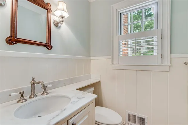 a spacious bedroom with two beds and window