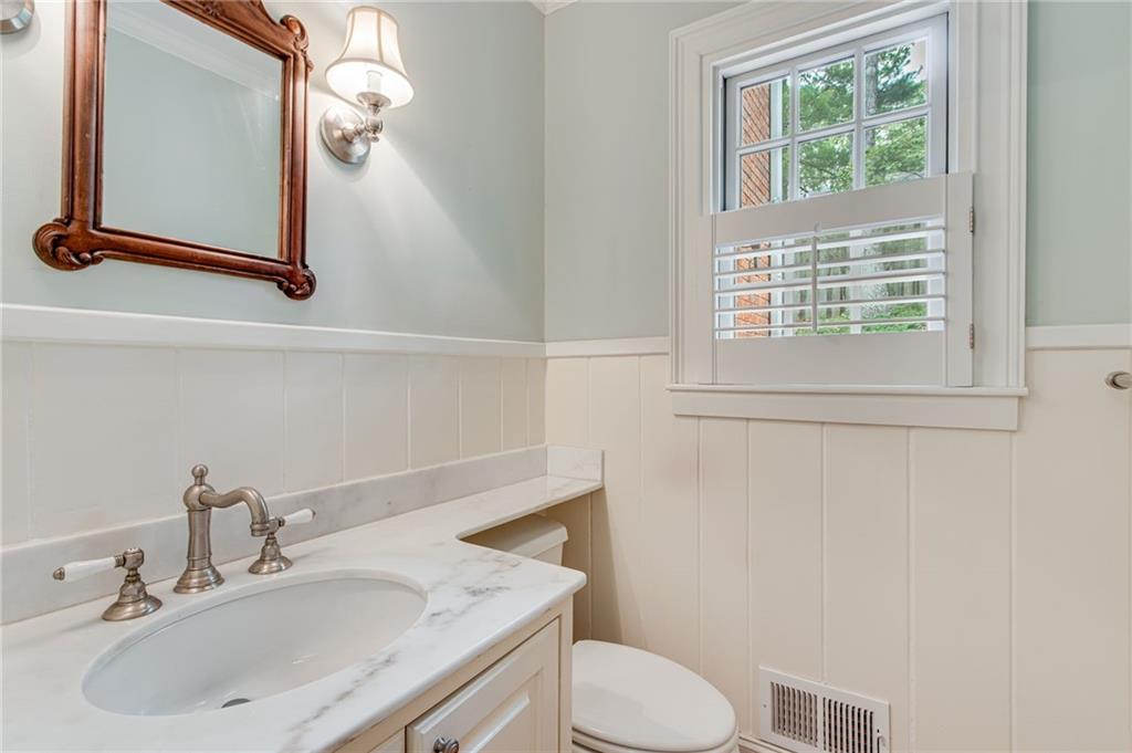 2626 Club Drive Gainesville, GA 30506 - Photo 44 of 71 a bathroom with a sink toilet and mirror