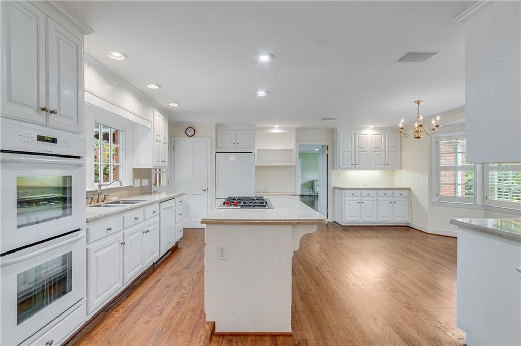 2626 Club Drive Gainesville, GA 30506 - Photo 47 of 71 a large kitchen with stainless steel appliances kitchen island a large counter top and a stove top oven