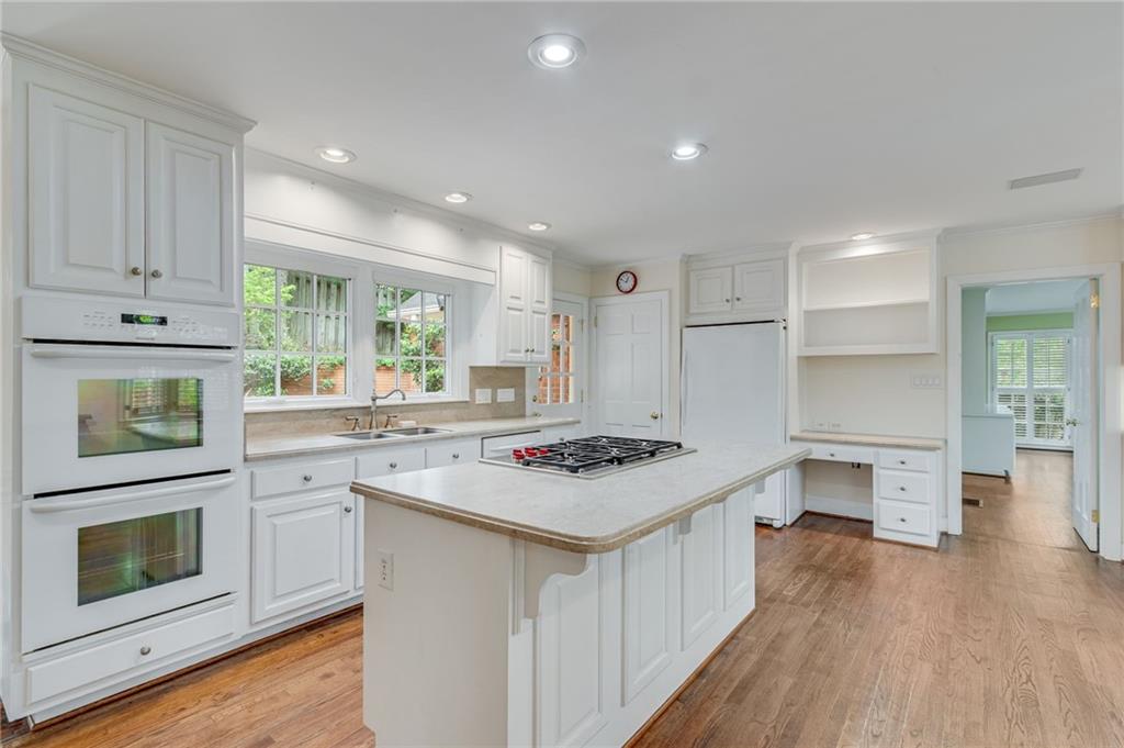 2626 Club Drive Gainesville, GA 30506 - Photo 48 of 71 a kitchen with a stove a sink and wooden floor