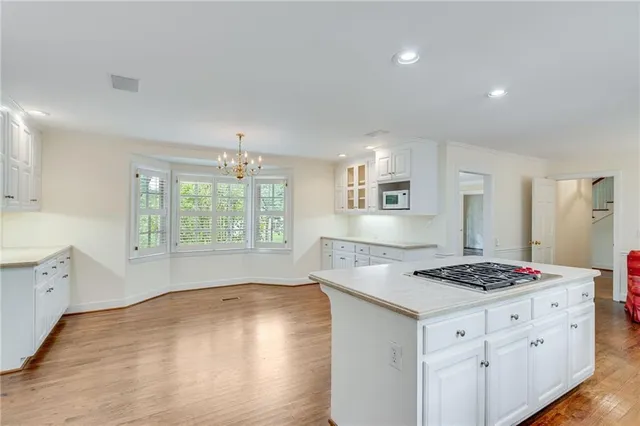 an empty room with a window and ceiling fan