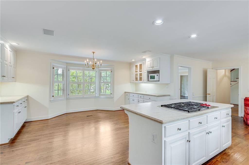 2626 Club Drive Gainesville, GA 30506 - Photo 49 of 71 a kitchen with granite countertop a stove sink and cabinets