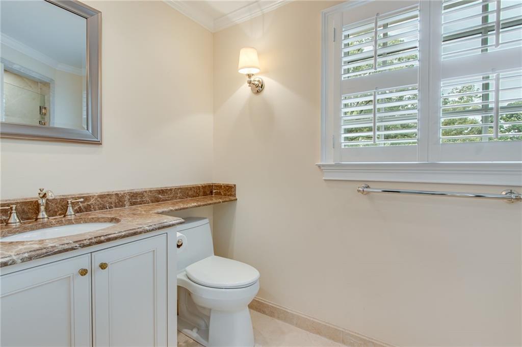 2626 Club Drive Gainesville, GA 30506 - Photo 66 of 71 a bathroom with a granite countertop toilet a sink and a window