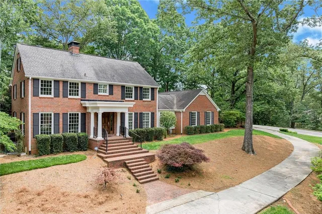 an aerial view of a house with a yard and lake view