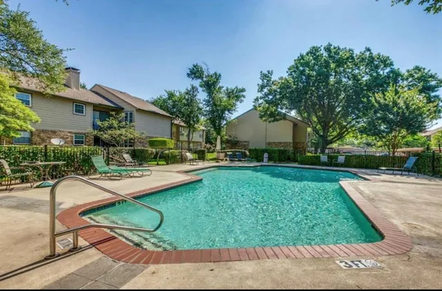 a view of a house with backyard patio and swimming pool