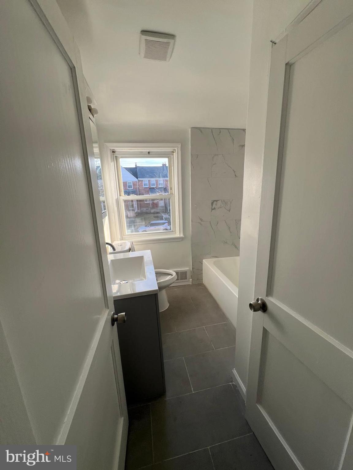 603 Braeside Road Baltimore, MD 21229 - Photo 17 of 30 a bathroom with a sink a toilet and shower