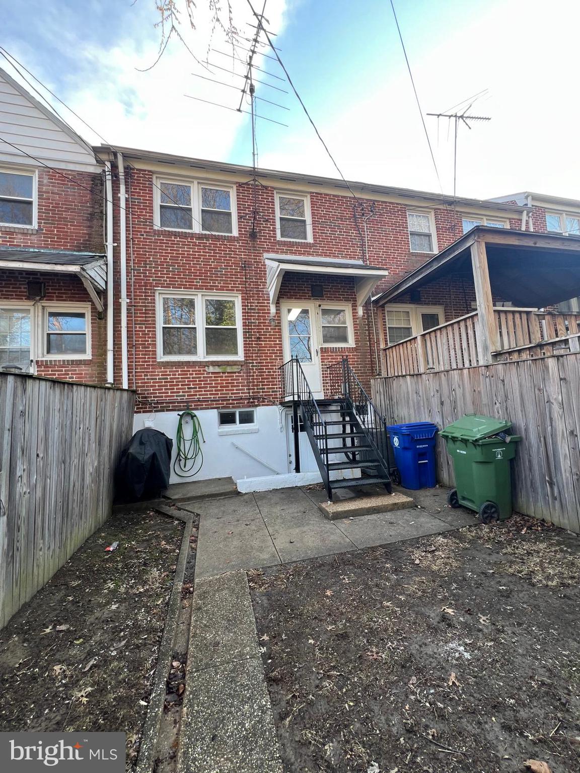 603 Braeside Road Baltimore, MD 21229 - Photo 30 of 30 a view of a brick house with many windows and barbeque grill
