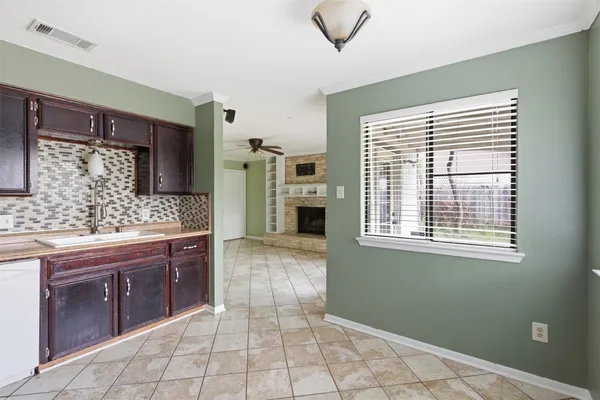 a spacious bathroom with a granite countertop sink a mirror and a bathtub