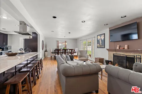 a living room with furniture flat screen tv and a fireplace