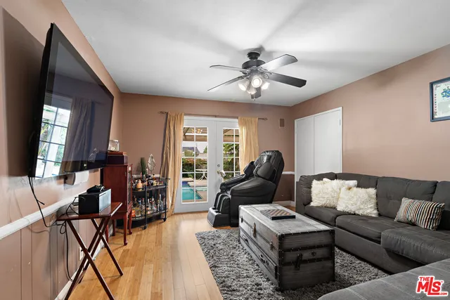 a living room with furniture and wooden floor