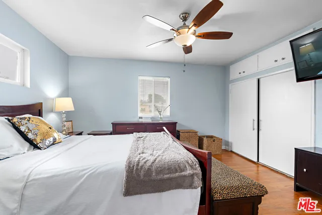 a bedroom with a bed and wooden floor