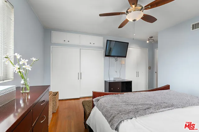 a bedroom with a bed and a flat screen tv