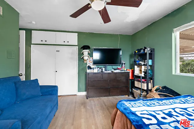 a bedroom with furniture and a flat screen tv