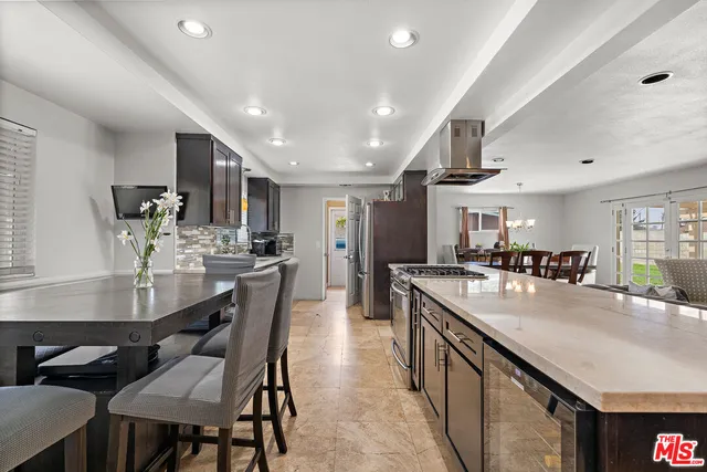 a large kitchen with a table and chairs