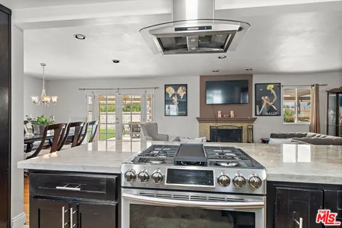a stove top oven sitting inside of a kitchen