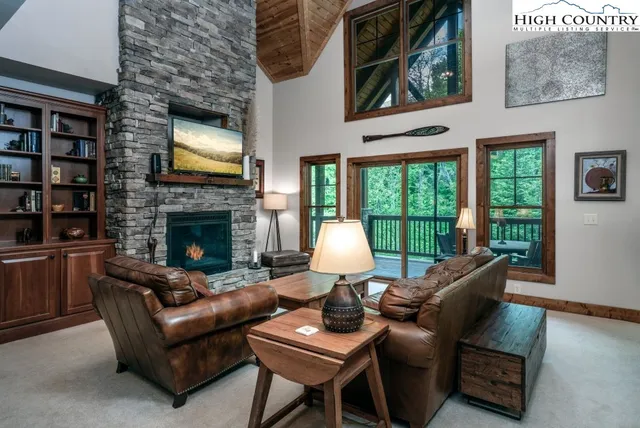 a living room with furniture flat screen tv and a fireplace