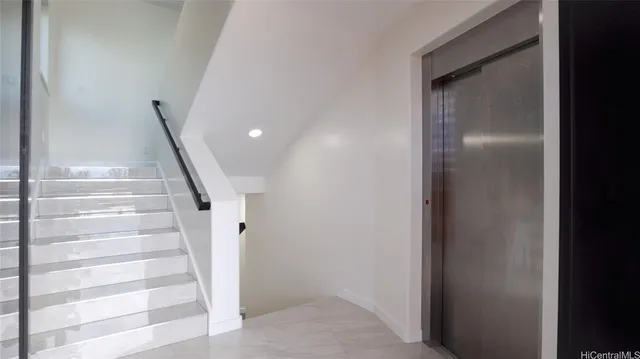 a bedroom with a large window and a bed