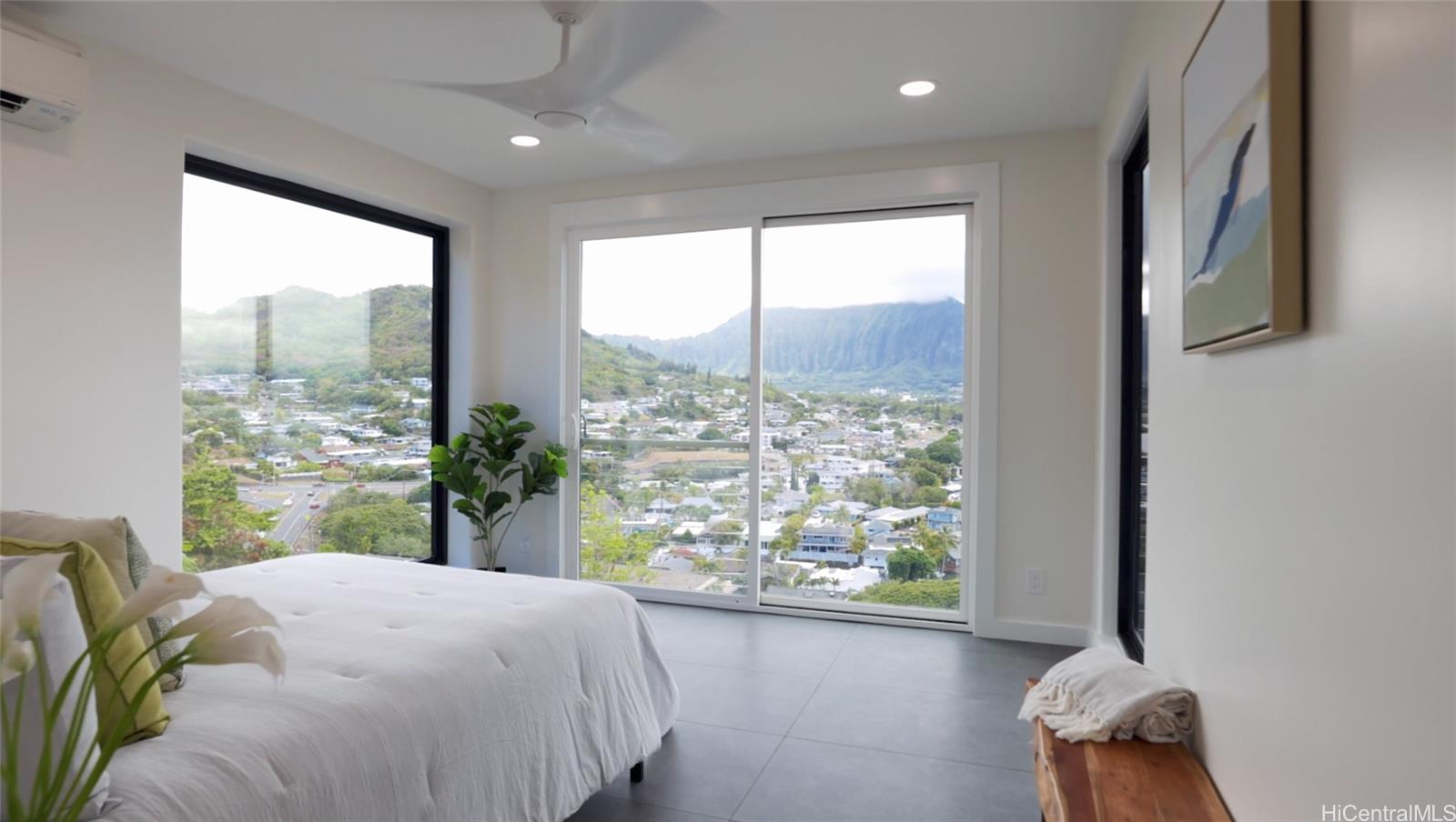 44-652 Kaneohe Bay Drive, Unit A Kaneohe, HI 96744 - Photo 22 of 25 a bedroom with a large bed and a large window