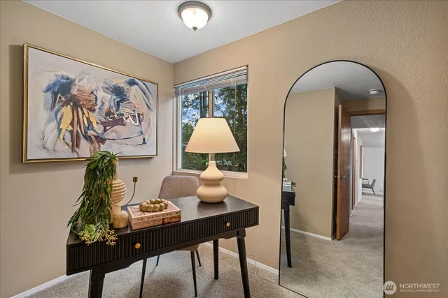a view of a workspace room with furniture and wooden floor
