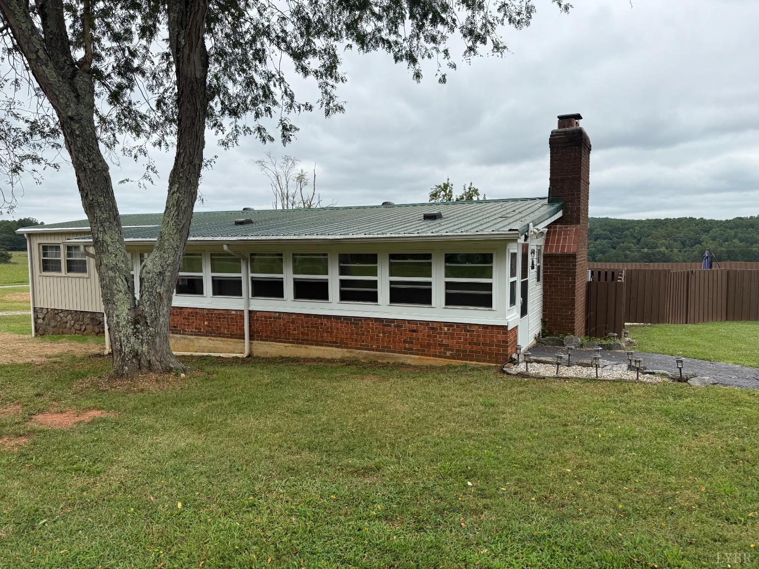 1046 Clarks Road Rustburg, VA 24588 - Photo 15 of 19 a view of a house with a yard and a large tree