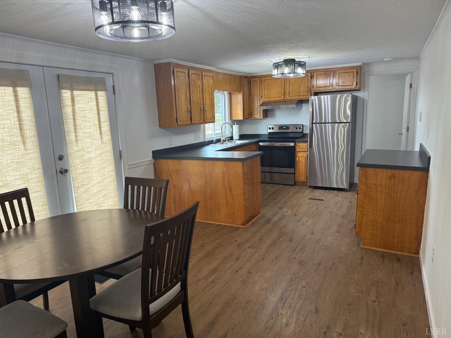 1046 Clarks Road Rustburg, VA 24588 - Photo 4 of 19 a kitchen with stainless steel appliances granite countertop a stove a refrigerator a sink a dining table and chairs