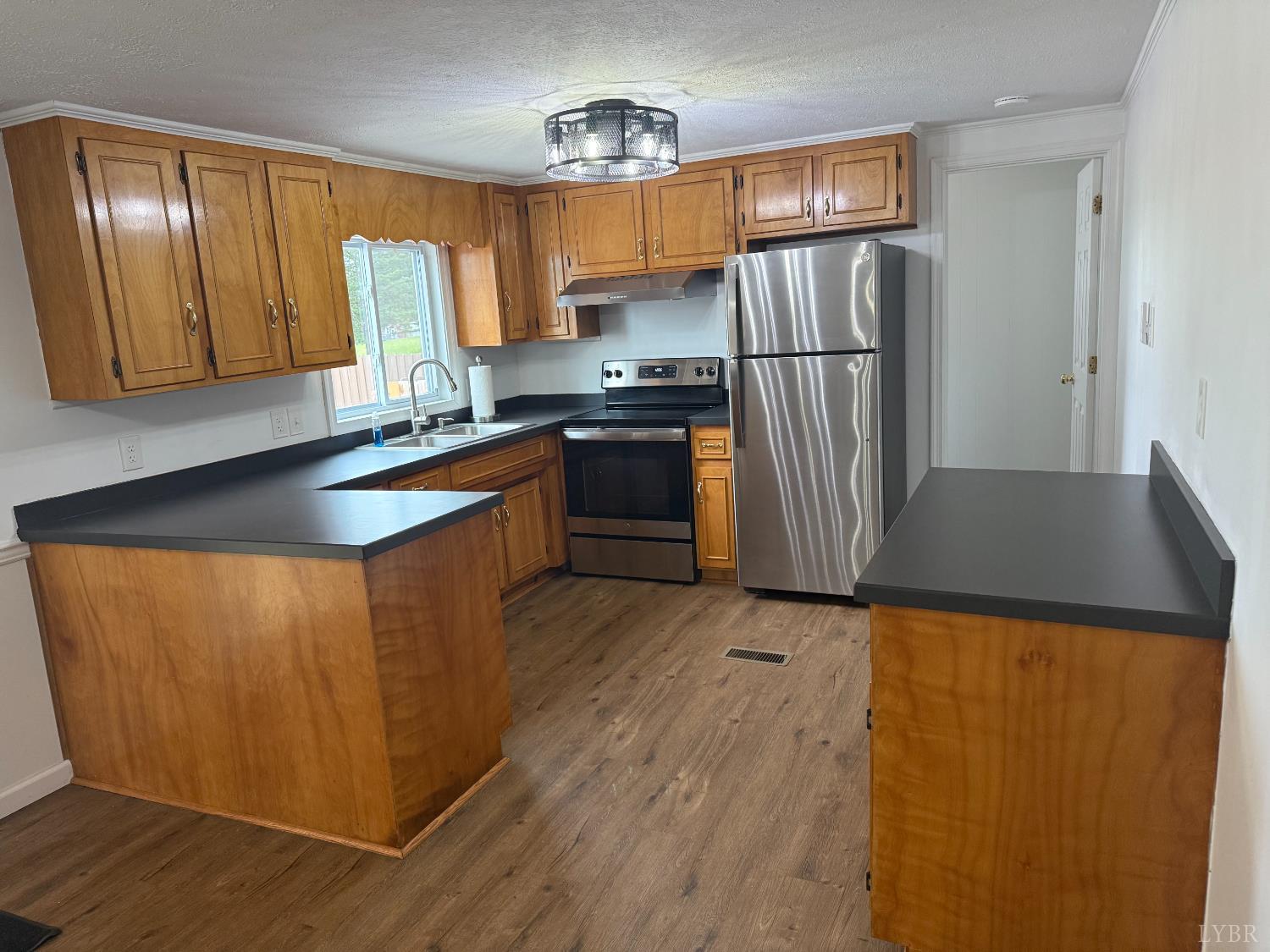 1046 Clarks Road Rustburg, VA 24588 - Photo 5 of 19 a kitchen with stainless steel appliances granite countertop a refrigerator a sink dishwasher and wooden cabinets with wooden floor