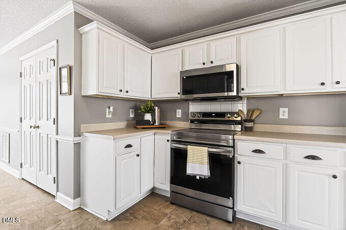 6733 Oviedo Drive Raleigh, NC 27603 - Photo 12 of 33 a kitchen with granite countertop white cabinets stainless steel appliances and sink