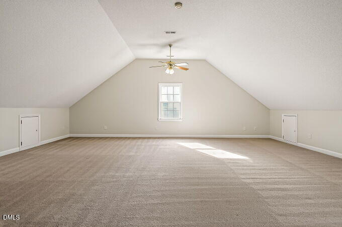 6733 Oviedo Drive Raleigh, NC 27603 - Photo 27 of 33 an empty room with windows and ceiling fan