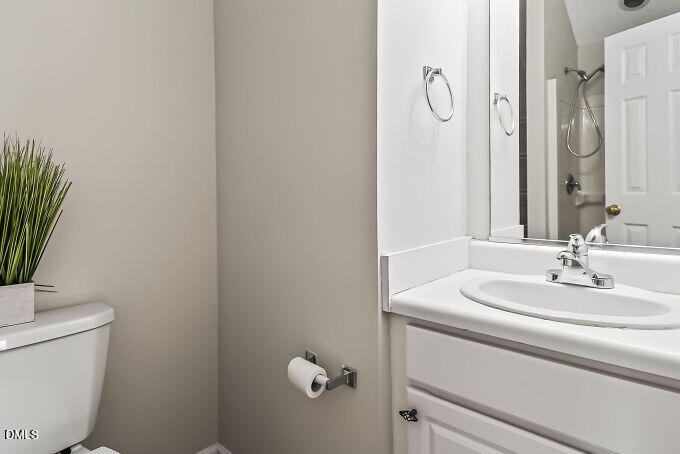 6733 Oviedo Drive Raleigh, NC 27603 - Photo 28 of 33 a bathroom with a sink and a mirror