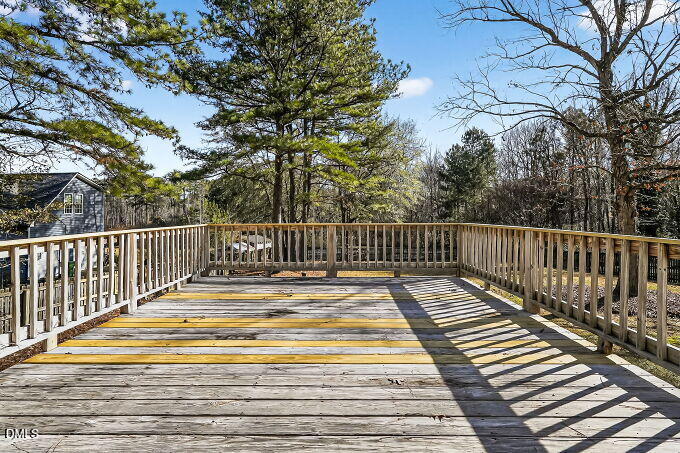6733 Oviedo Drive Raleigh, NC 27603 - Photo 30 of 33 a view of balcony with wooden floor and fence