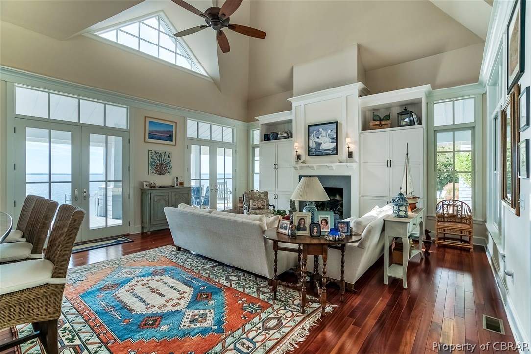 904 Queenstown Road Lancaster, VA 22503 - Photo 10 of 40 Great Room: 21 x 21 with vaulted ceiling and ceiling fan, twin 10? tall x 6? wide French doors, all windows 10? tall with transoms, gas fireplace with built-ins either side.