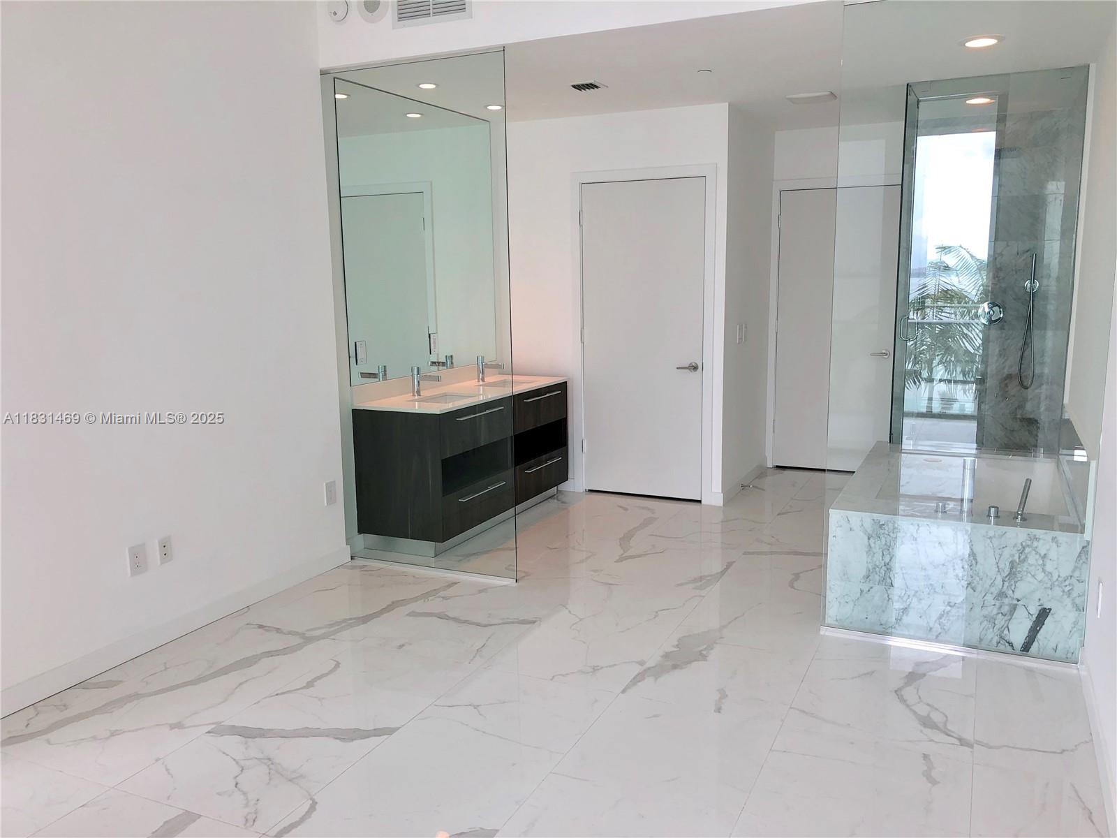 480 Northeast 31st Street, Unit 705 Miami, FL 33137 - Photo 7 of 32 a view of room with bathroom and mirror