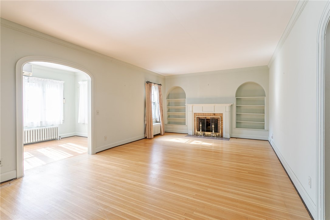 581 Claybourne Road Brighton, NY 14618 - Photo 15 of 40 Formal living room with built-ins and fireplace