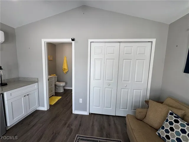 a bedroom with furniture and a flat screen tv