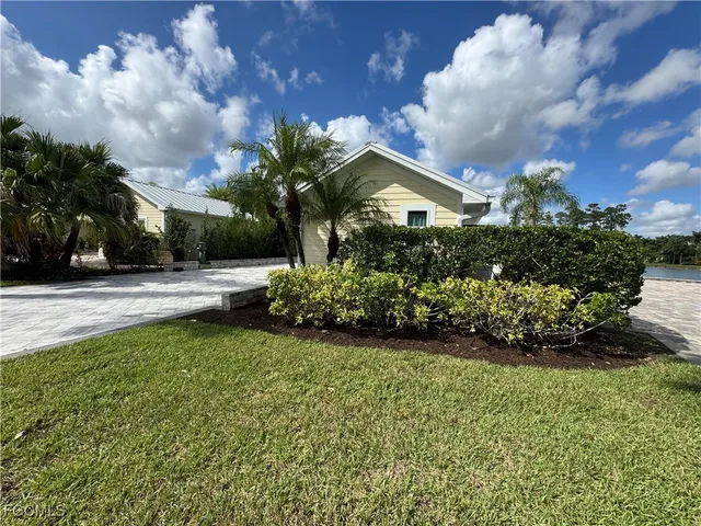 a front view of a house with a yard and a garage