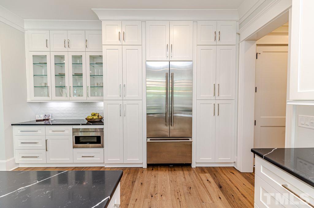 10822 Grand Journey Avenue Raleigh, NC 27614 - Photo 11 of 41 a kitchen with stainless steel appliances a refrigerator and a stove top oven