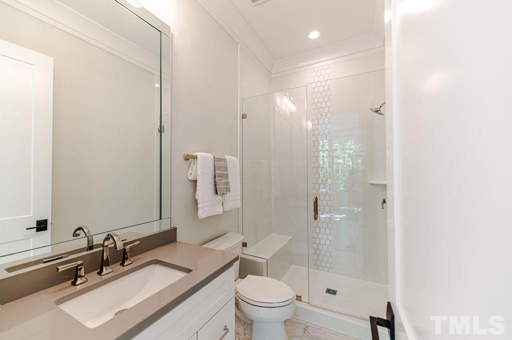 10822 Grand Journey Avenue Raleigh, NC 27614 - Photo 14 of 41 a bathroom with a sink a toilet a mirror and shower