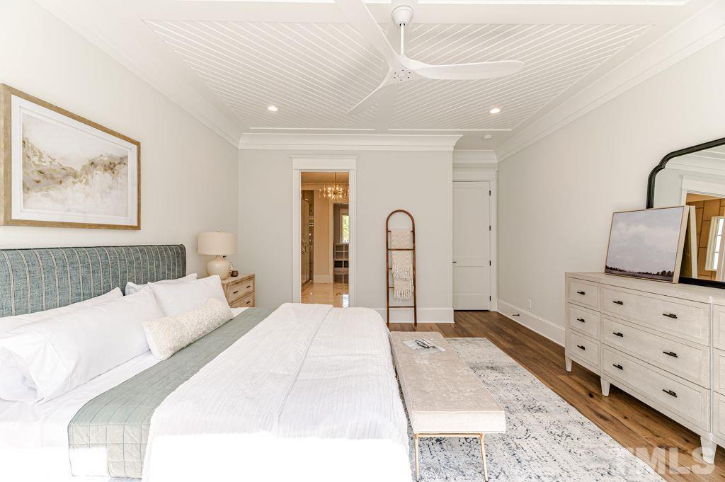 10822 Grand Journey Avenue Raleigh, NC 27614 - Photo 19 of 41 a bedroom with a bed and a flat screen tv