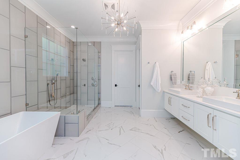 10822 Grand Journey Avenue Raleigh, NC 27614 - Photo 20 of 41 a bathroom with a double vanity sink a toilet and bathtub
